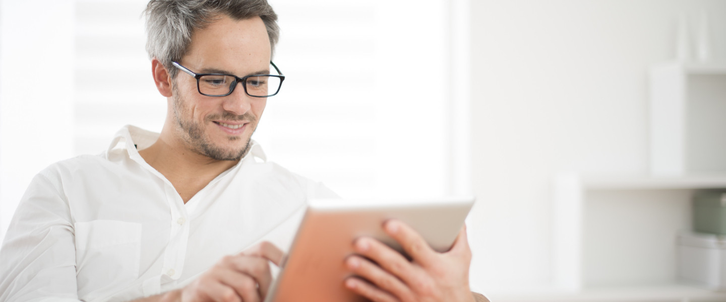 Un homme qui lit une publication sur son iPad